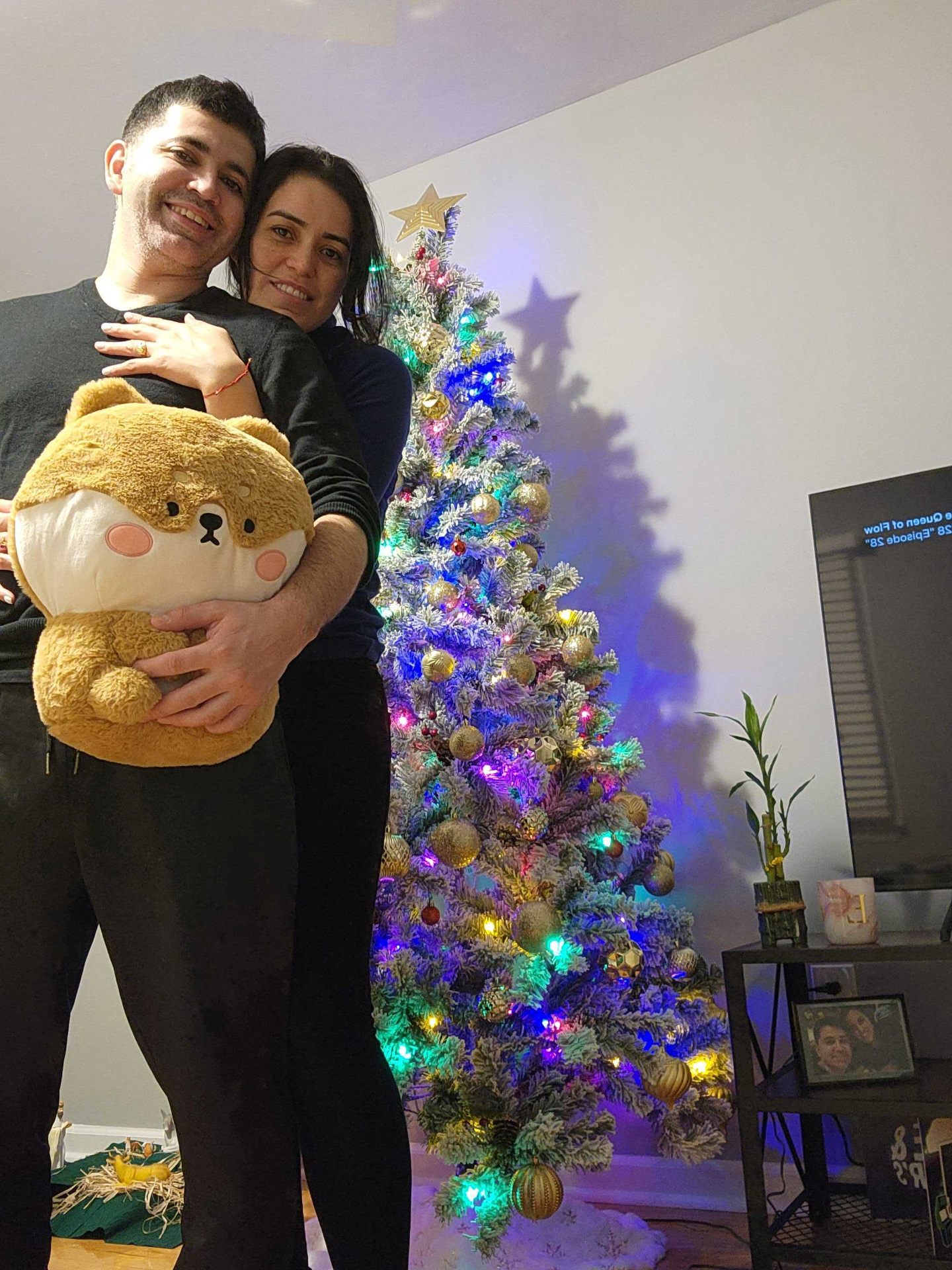 Angélica and Esteban by a Christmas tree