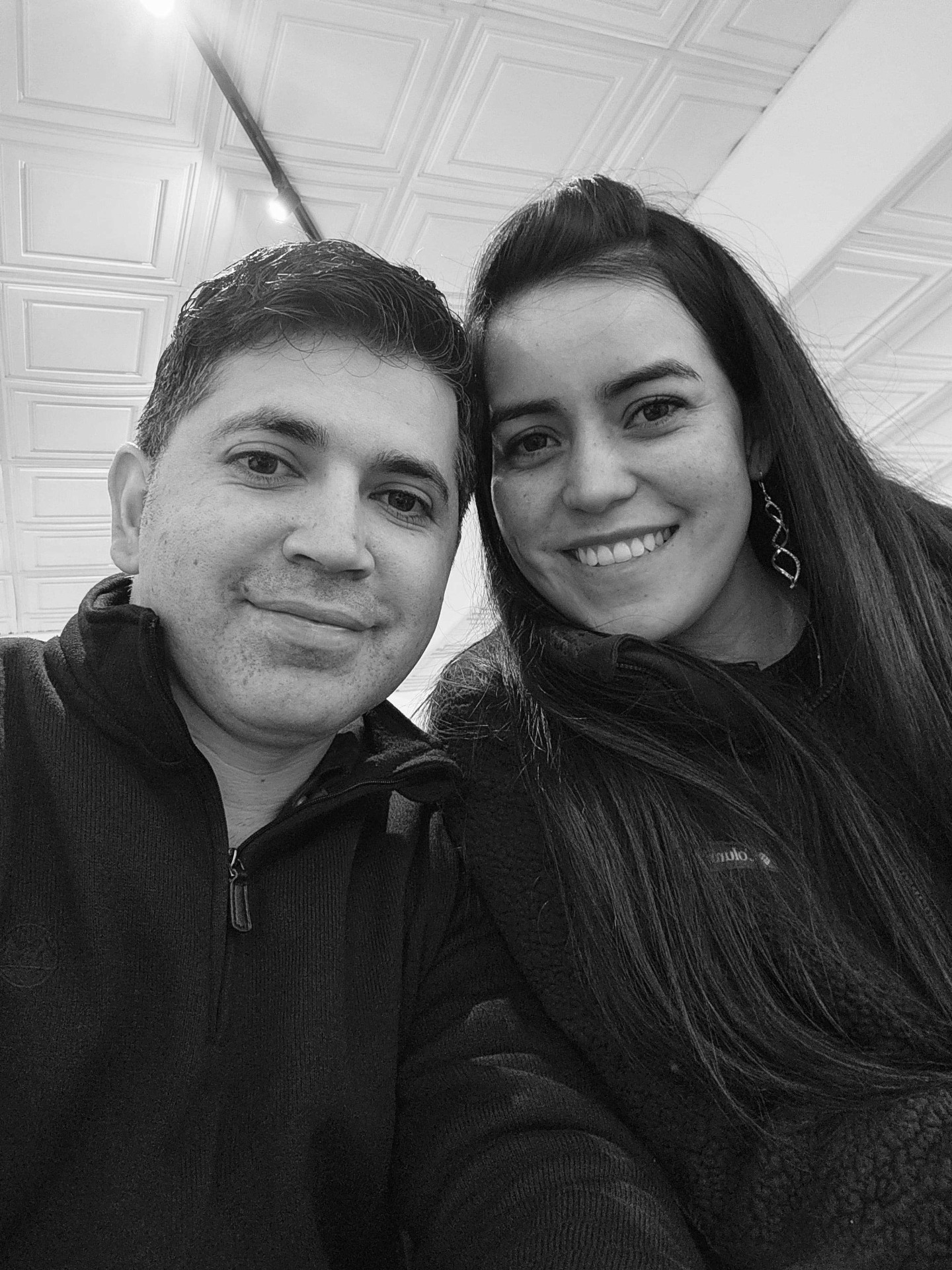 Black and white selfie of Angélica and Esteban smiling