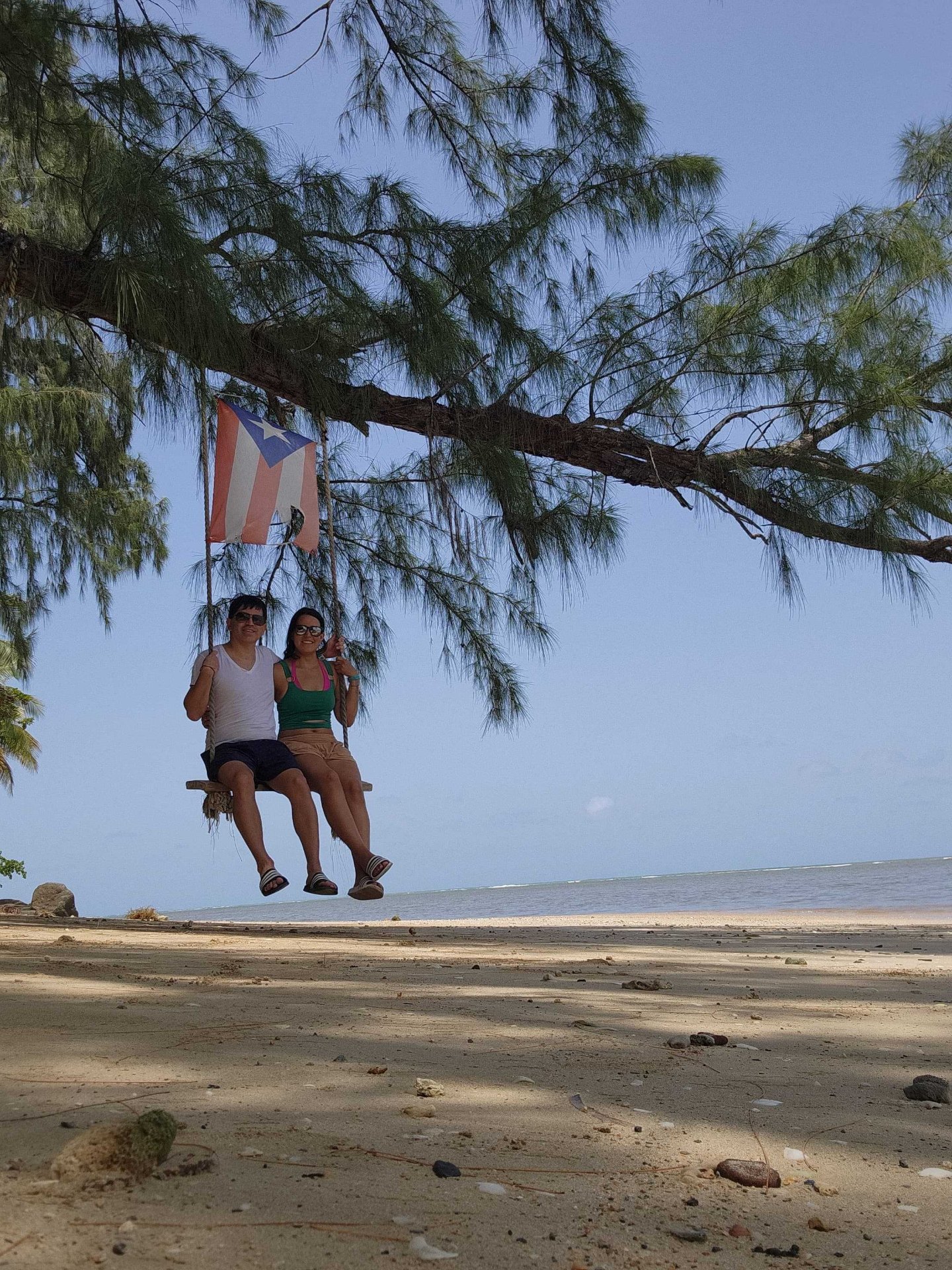 Angélica and Esteban on a beach swing in Puerto Rico